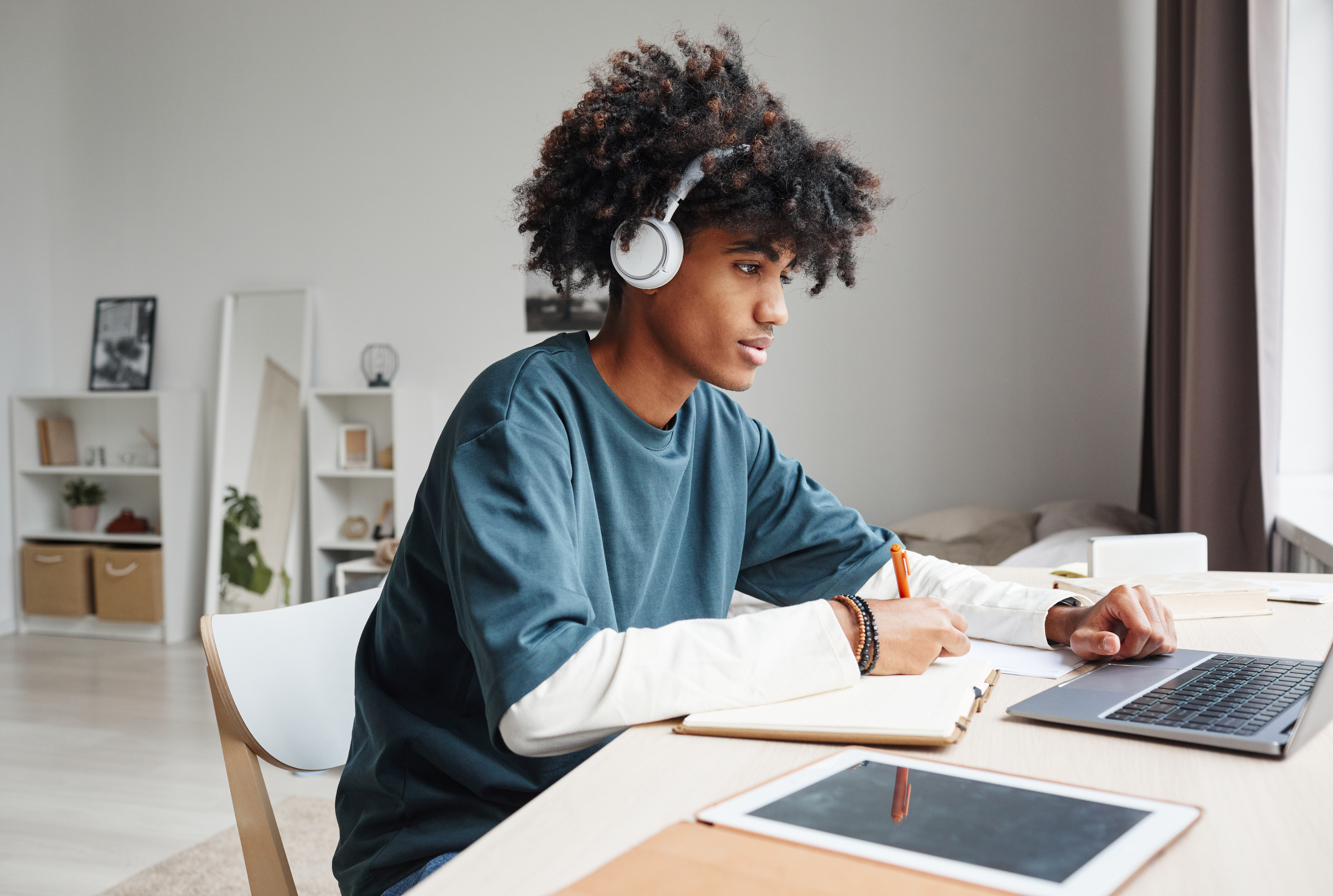 Student using technology and wearing headphones